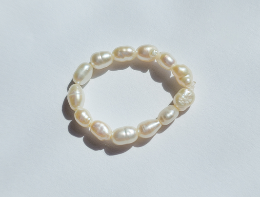 A freshwater pearl ring laid on a white background.